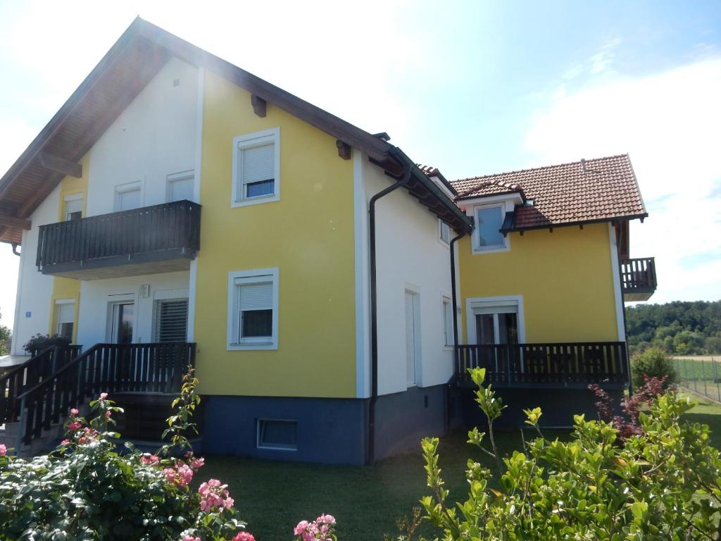 ein gelbes und weißes Haus mit einem Hof in der Unterkunft Appartement Huber in Lutzmannsburg