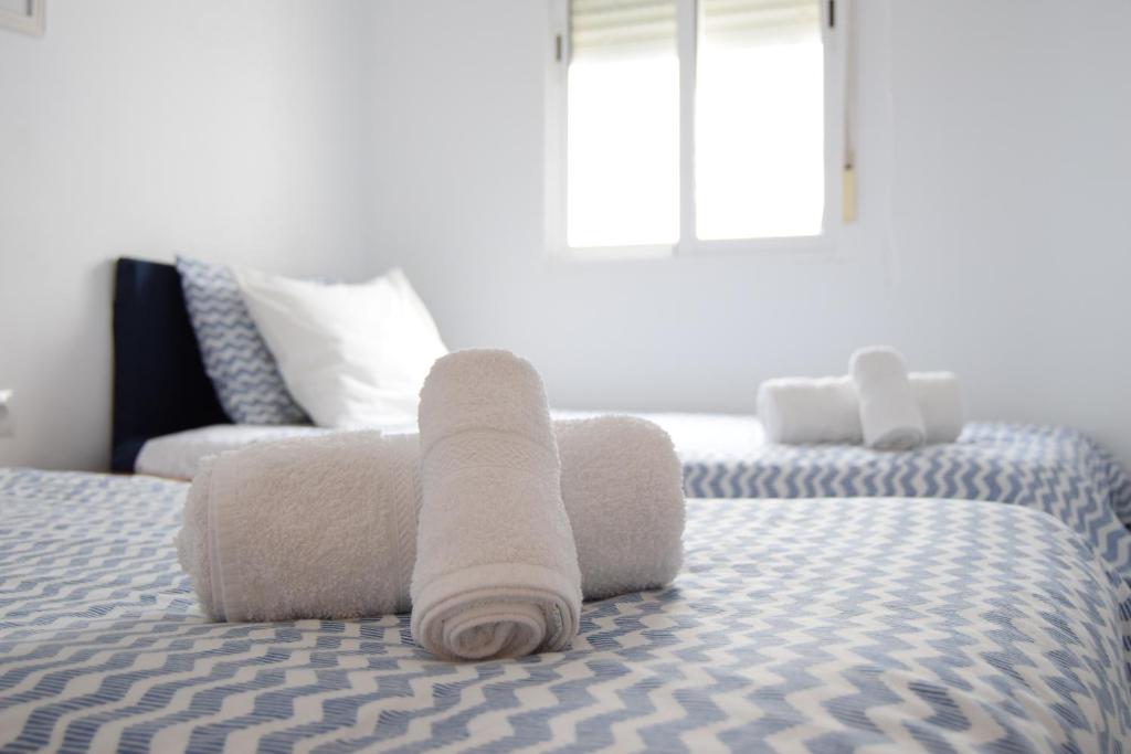 A bed or beds in a room at Enjoy Sevilla