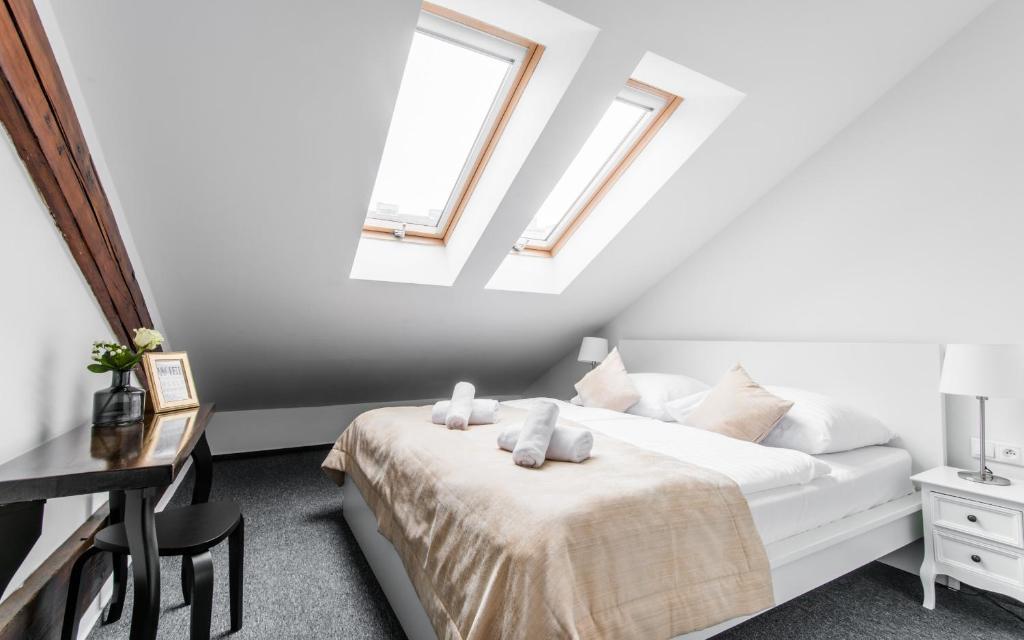 A bed or beds in a room at Downtown Bratislava B&B