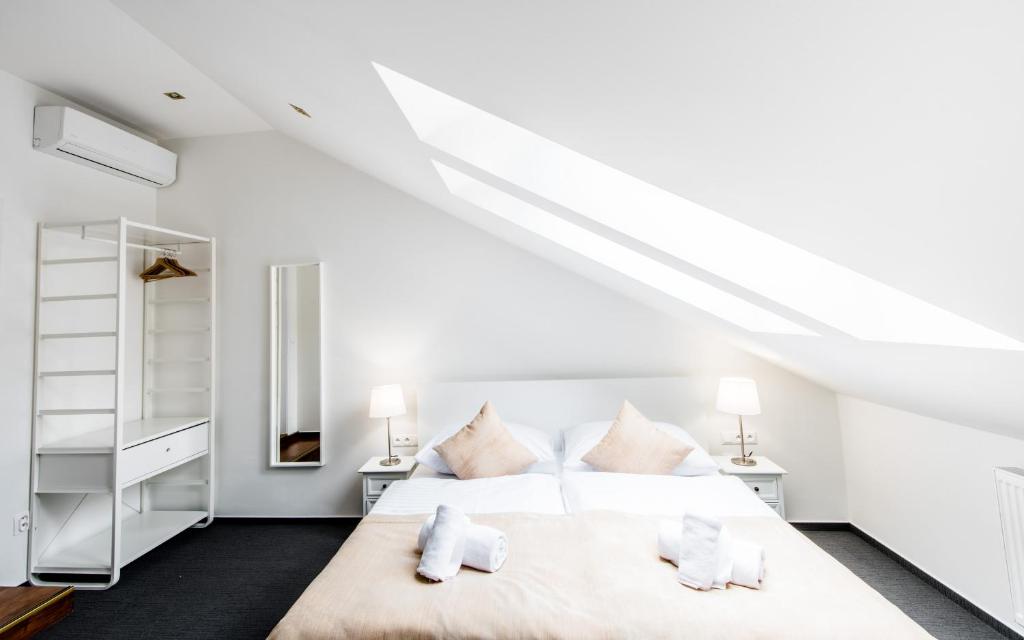 A bed or beds in a room at Downtown Bratislava B&B