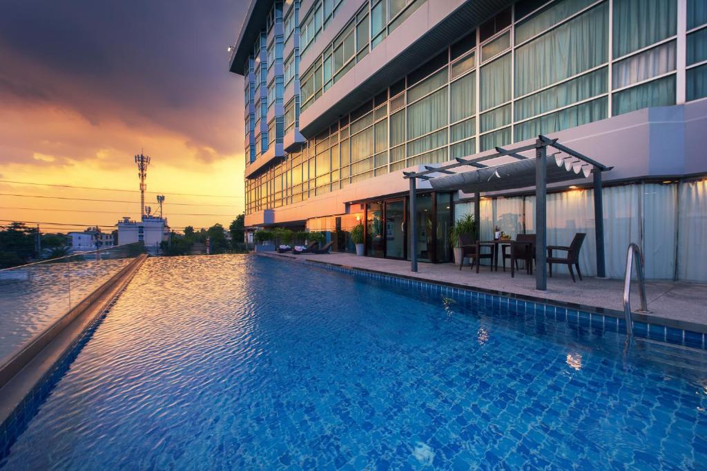 a large swimming pool in front of a building at Siam Mandarina Hotel - Free BKK Airport Shuttle in Lat Krabang