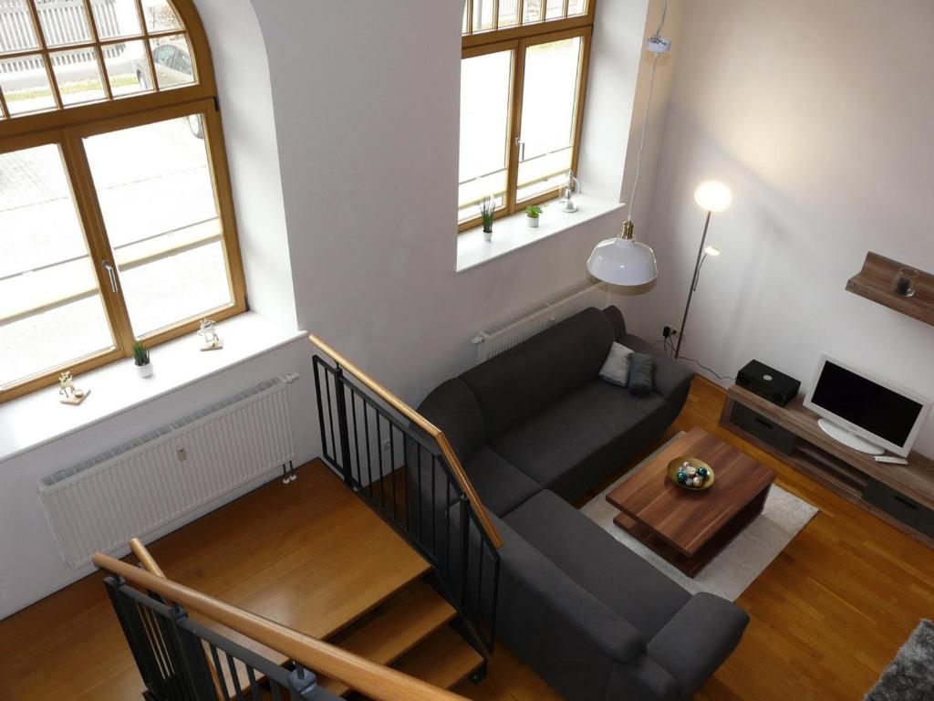 a living room with a couch and a table at Ferienwohnung Kampenwand-Loft in Aschau im Chiemgau