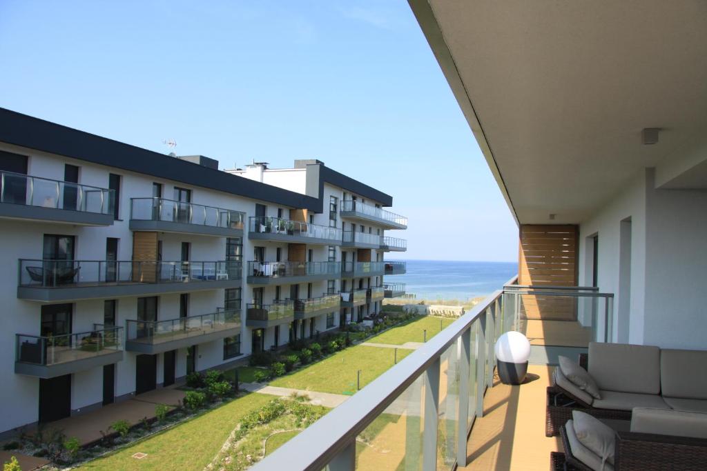 an apartment balcony with a view of the ocean at Apartament 36 Gardenia Seaside - Aprent in Dziwnów