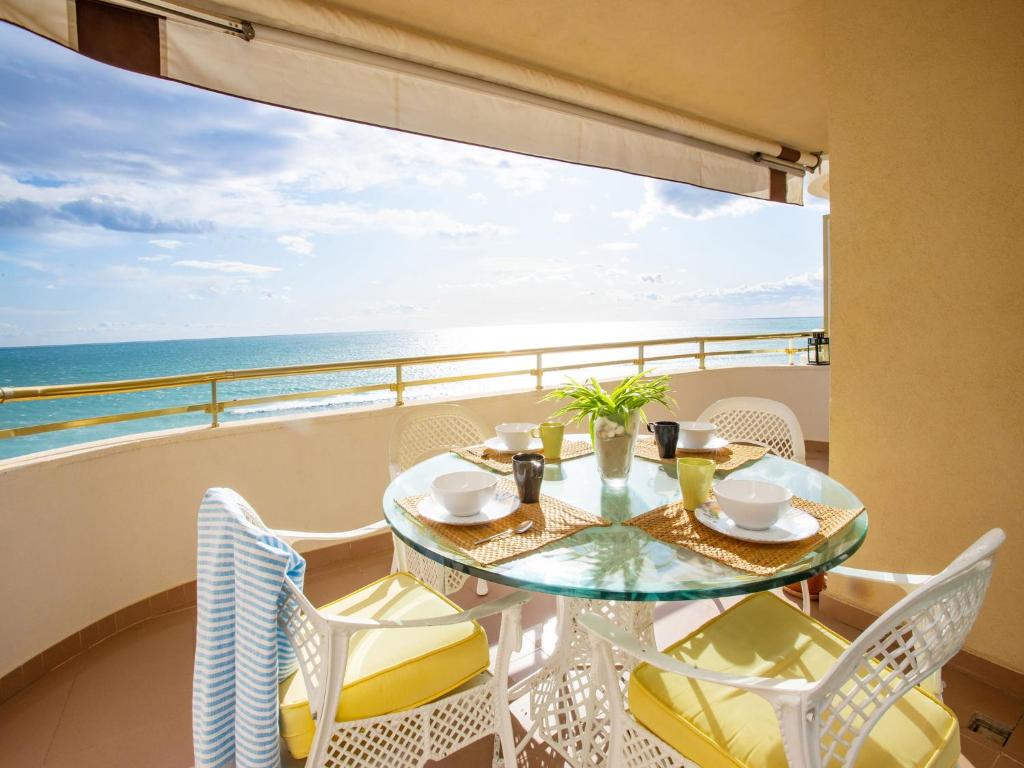 una mesa y sillas en un balcón con vistas al océano en Apartment Front Beach by Interhome, en Calafell