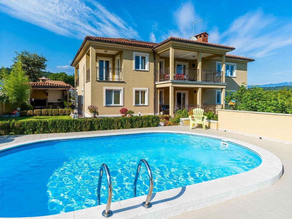 a villa with a swimming pool in front of a house at Apartment Kate-3 by Interhome in Rukavac