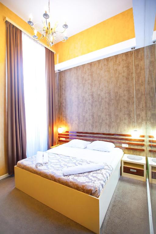 Postel nebo postele na pokoji v ubytování Rustaveli Hotel
