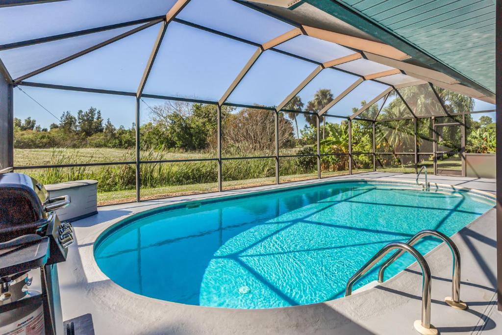 an indoor swimming pool with a glass enclosure at Barsl Retreat in Cape Coral