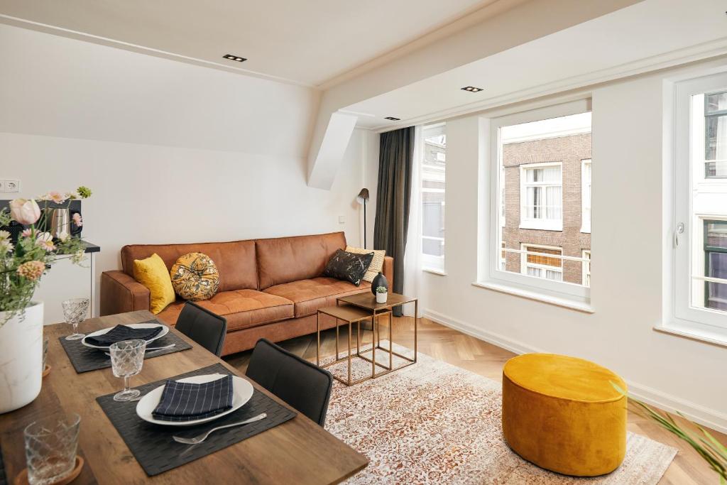 a living room with a couch and a table at Damrak Short Stay Amsterdam in Amsterdam