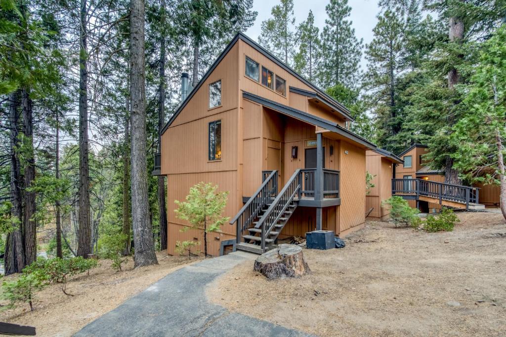 a house in the woods with a staircase at Hidden Haven Condominium in Shaver Lake
