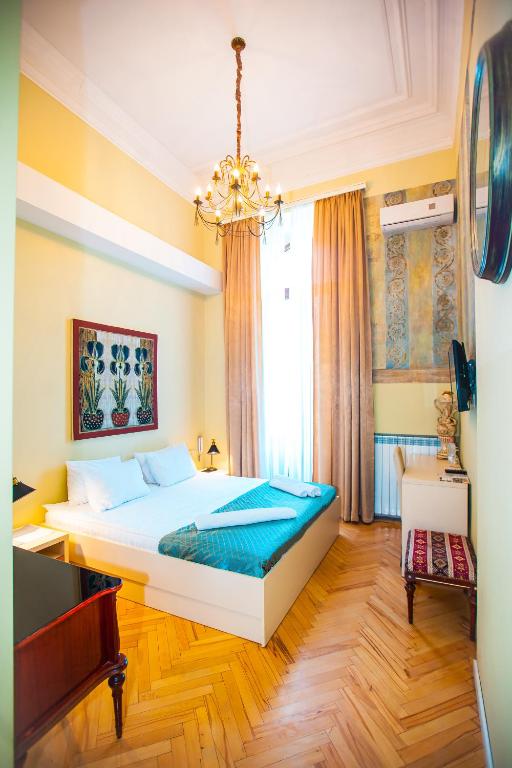 Postel nebo postele na pokoji v ubytování Rustaveli Hotel