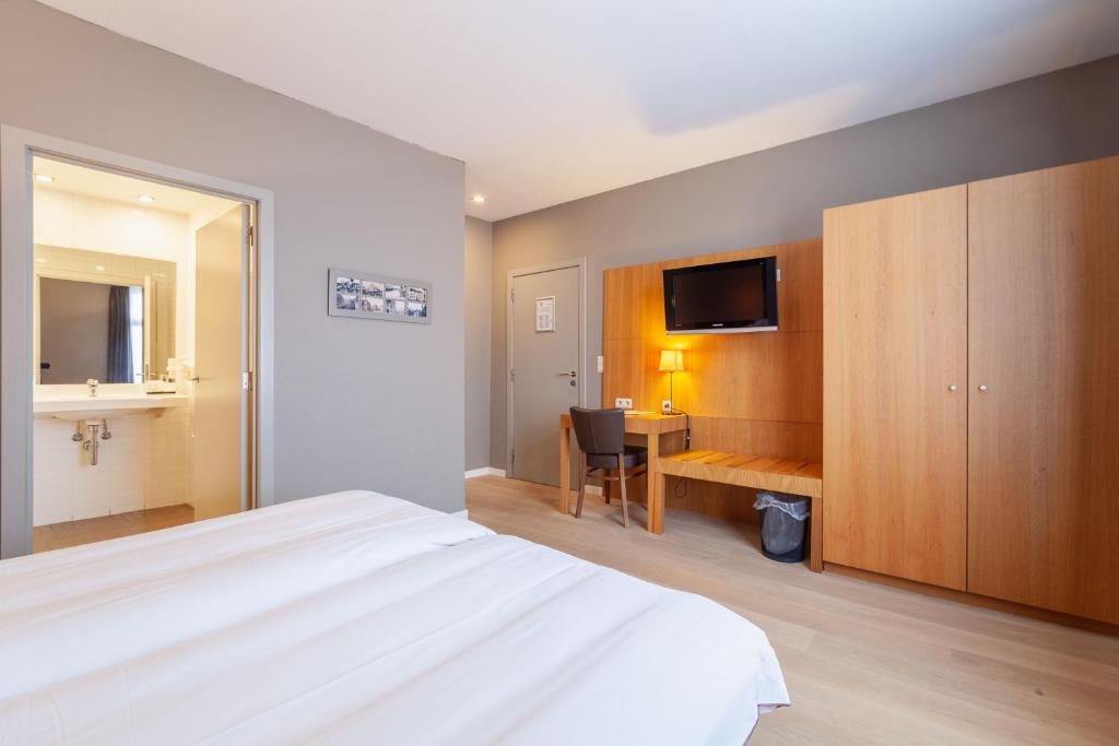 Postel nebo postele na pokoji v ubytování Hotel Hof van Aragon