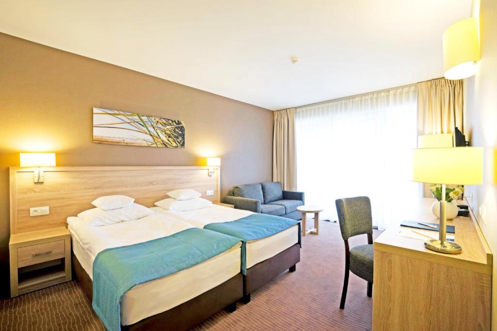 Postel nebo postele na pokoji v ubytování Tristan Hotel & SPA