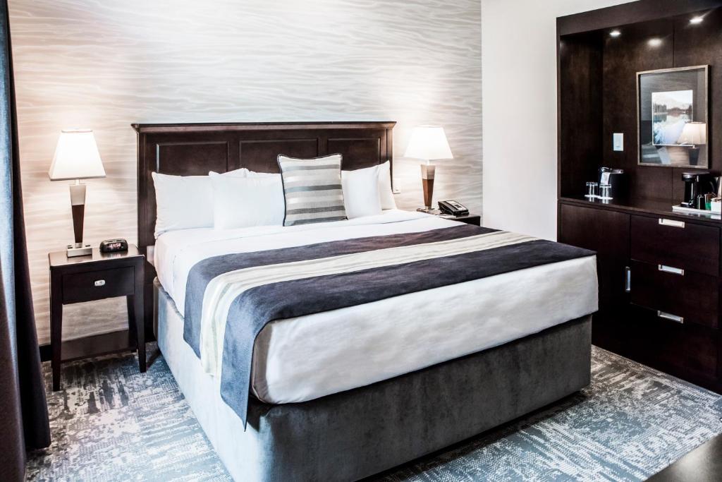 a bedroom with a large bed and two night stands at Charltons Banff in Banff