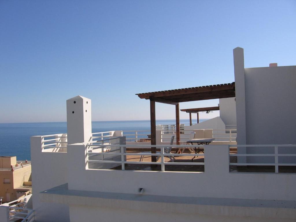 a white building with a view of the ocean at Apartahotel Vistamar San José in San José