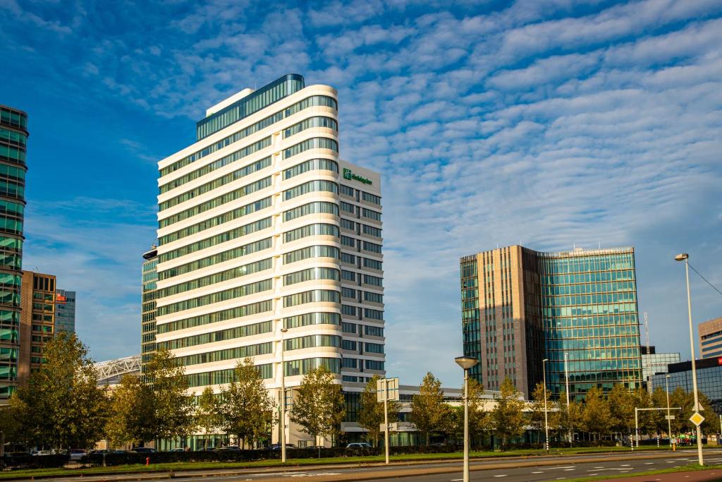 a tall white building in a city at Holiday Inn Express Amsterdam Arena Towers, an IHG Hotel in Amsterdam