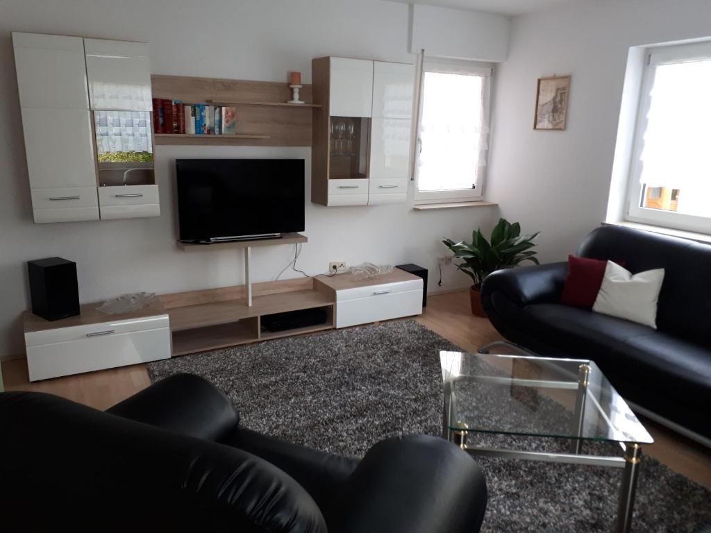 a living room with a couch and a tv at Ferienwohnung Brand in Creglingen