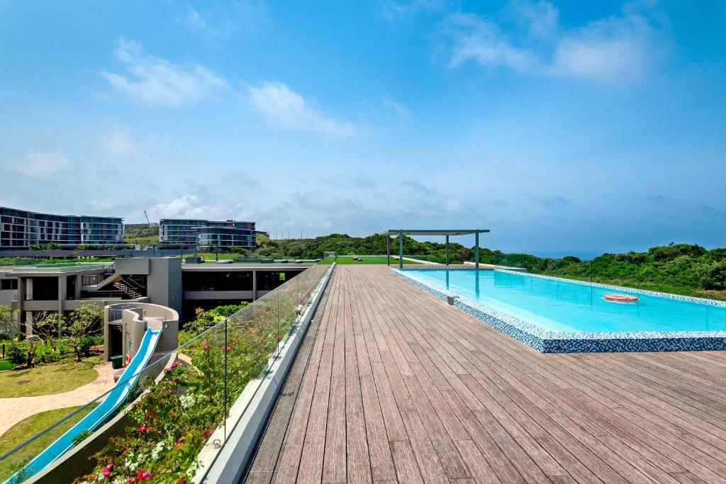 a swimming pool on the roof of a building at Pebble Beach 128 Umdloti Durban in Umdloti