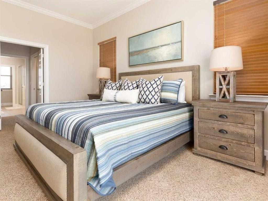 a bedroom with a large bed and a night stand at Windswept by Meyer Vacation Rentals in Gulf Shores