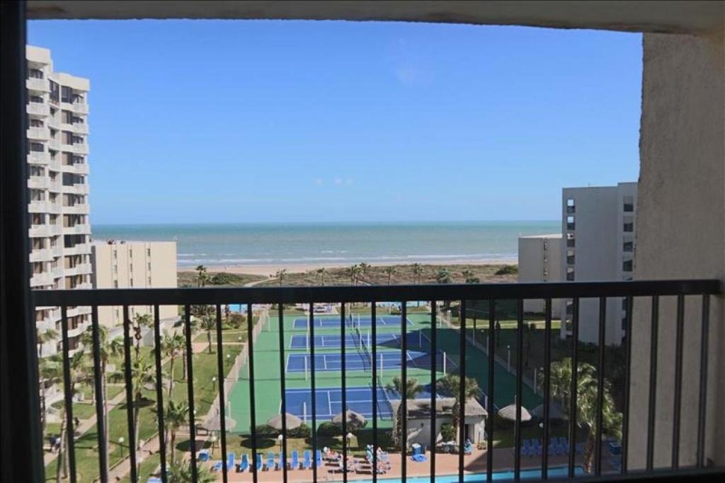 a balcony with a view of a pool and the ocean at Saida III Condos S3805 in South Padre Island