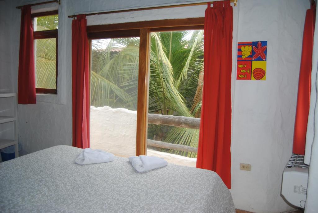 Postel nebo postele na pokoji v ubytování Hostal Galapagos by Bar de Beto