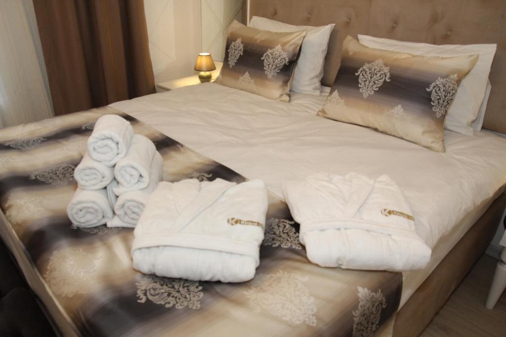 a bed with white towels on it at Kispet Deluxe Hotels&Suites in Oberhausen