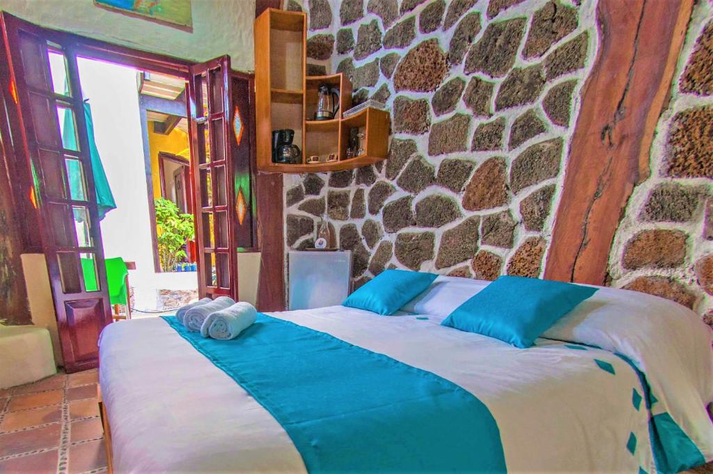 Säng eller sängar i ett rum på Casa del Lago Lodging House
