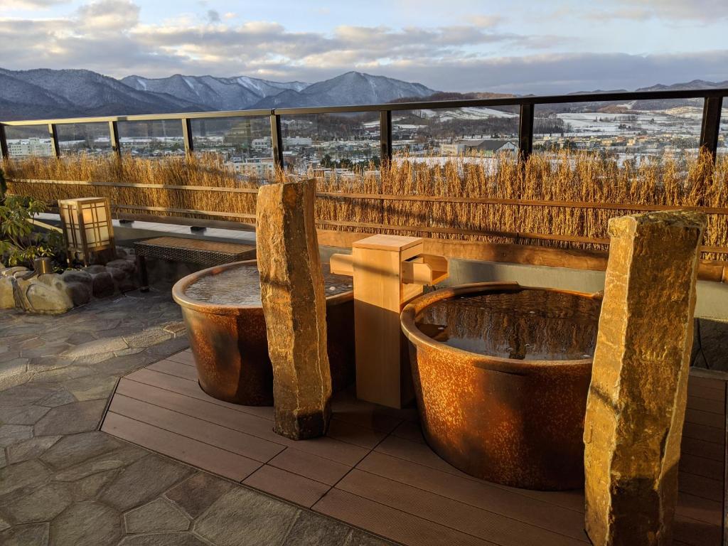a bath tub sitting on the side of a building at La Vista Furano Hills Natural Hot Spring in Furano