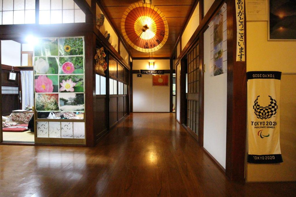an empty hallway of a building with paintings on the walls at Ohanabatake in Tsuruoka