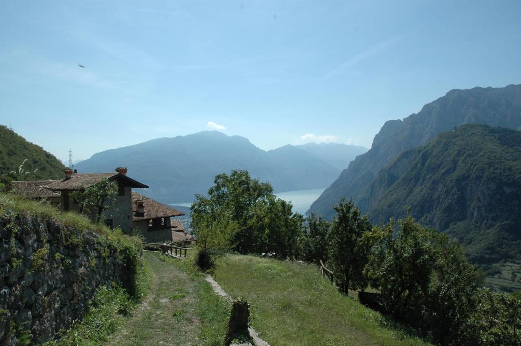 a view of a valley with mountains and a house at Casa Calvola holiday home in Tenno