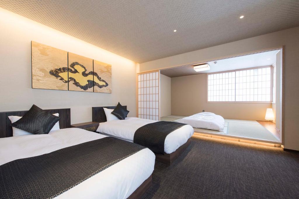 Postel nebo postele na pokoji v ubytování Hotel ZIZI Kyoto Gion