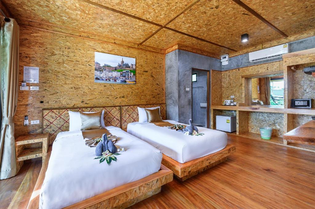Postel nebo postele na pokoji v ubytování Baan Check In