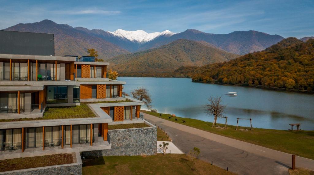 a building with a view of a lake and mountains at Kvareli Lake Resort in Kvareli