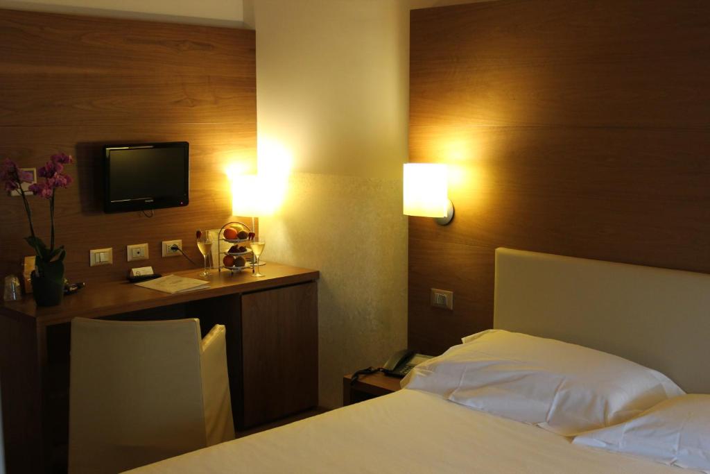 Postel nebo postele na pokoji v ubytování Hotel Operà