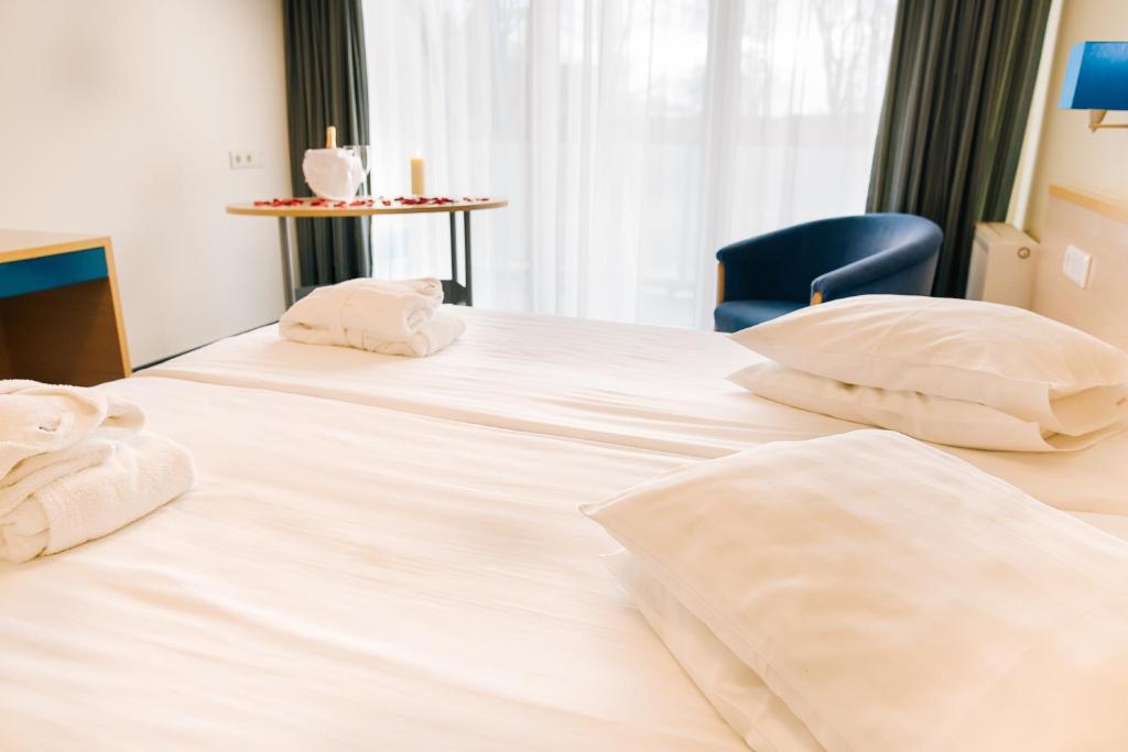 Voodi või voodid majutusasutuse Asa Spa Hotel toas