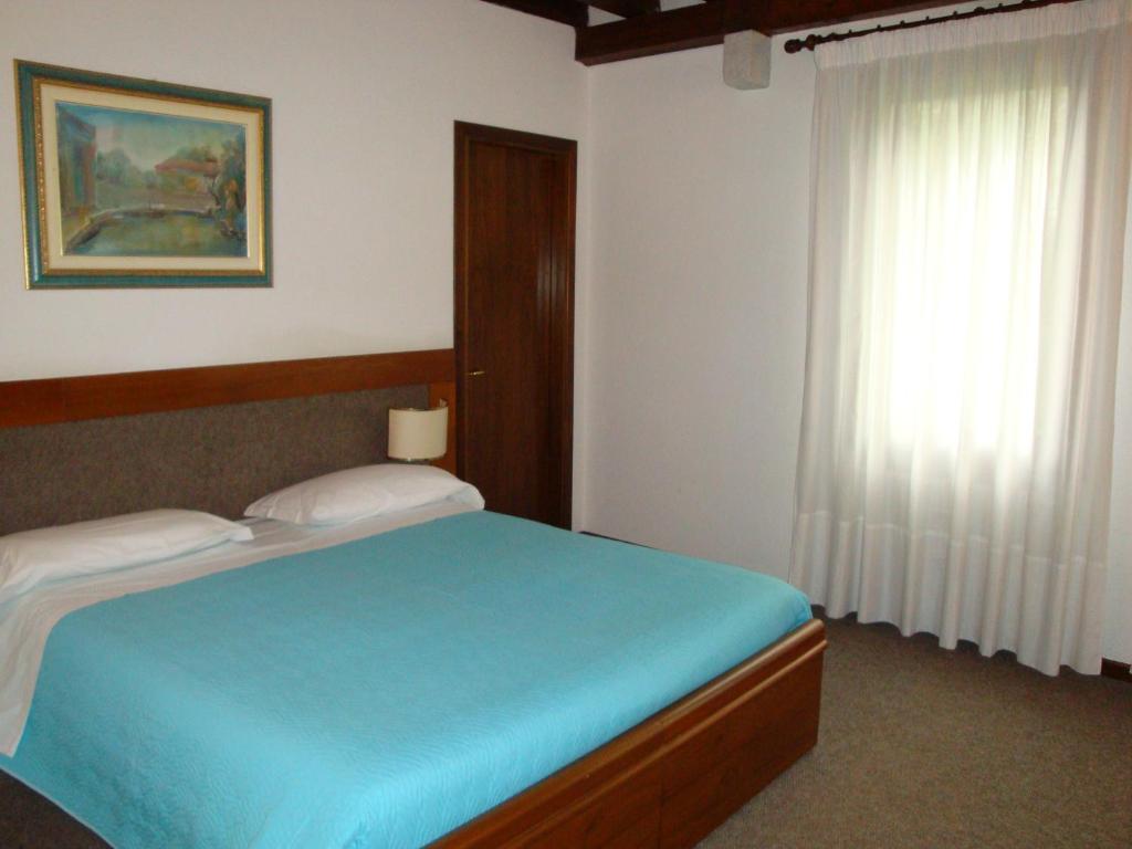 Postel nebo postele na pokoji v ubytování Sporting Hotel Ragno D'oro