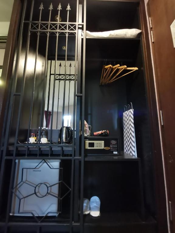a black cabinet with a microwave in it at Kimberley Hotel Georgetown in George Town
