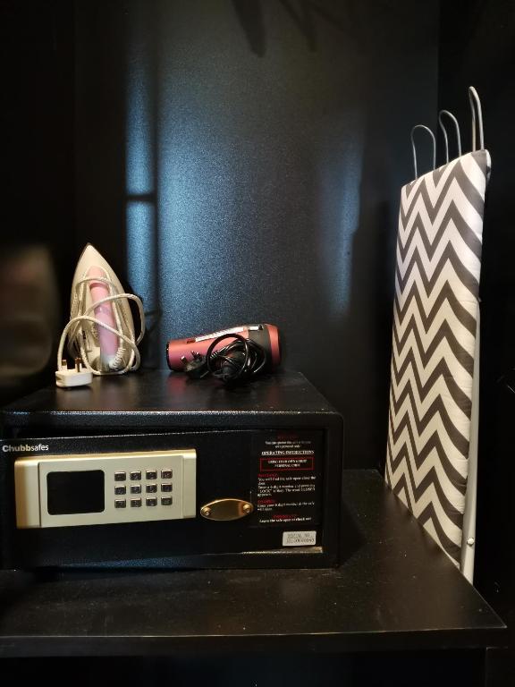 a microwave sitting on a table next to a bag at Kimberley Hotel Georgetown in George Town