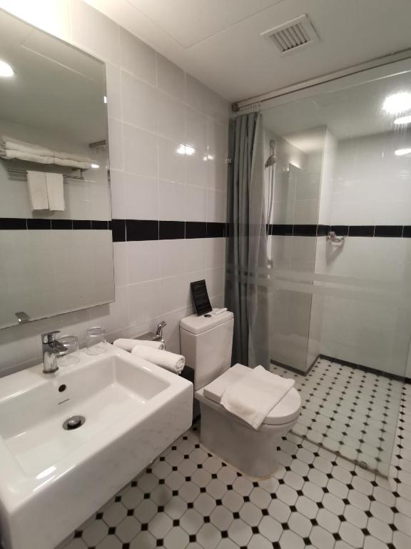a bathroom with a sink and a toilet and a shower at Kimberley Hotel Georgetown in George Town