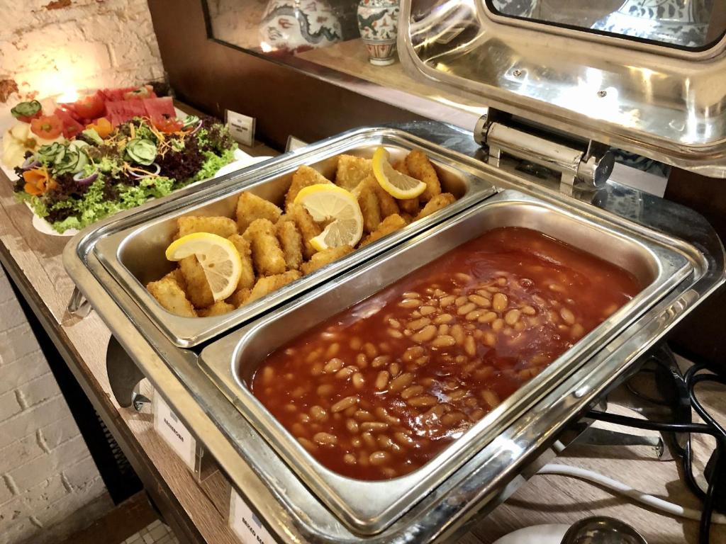 a buffet with a tray of beans and other food at Kimberley Hotel Georgetown in George Town