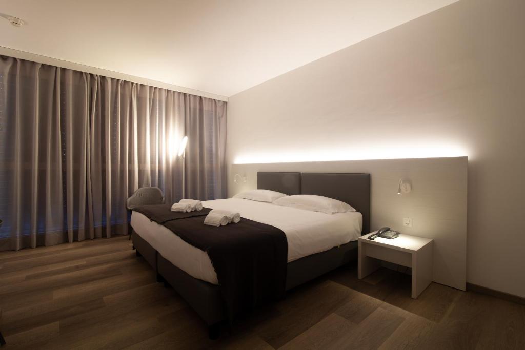 a hotel room with a bed and a window at Hotel Albergo Milano in Mendrisio