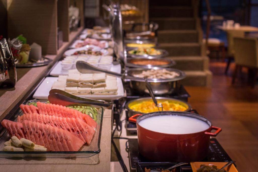 a buffet line with many different types of food at Green World JianPei in Taipei
