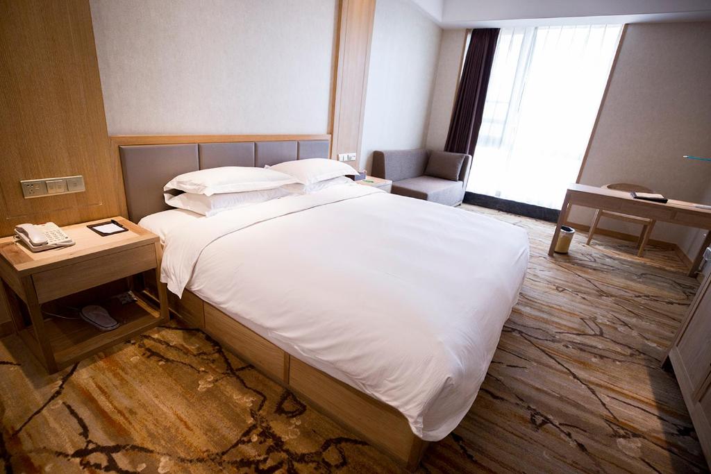 Postel nebo postele na pokoji v ubytování Metropark Hotel Yingkun Beijing