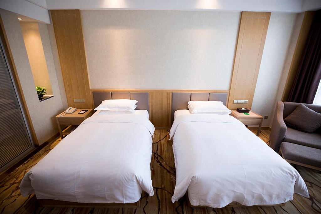 Postel nebo postele na pokoji v ubytování Metropark Hotel Yingkun Beijing