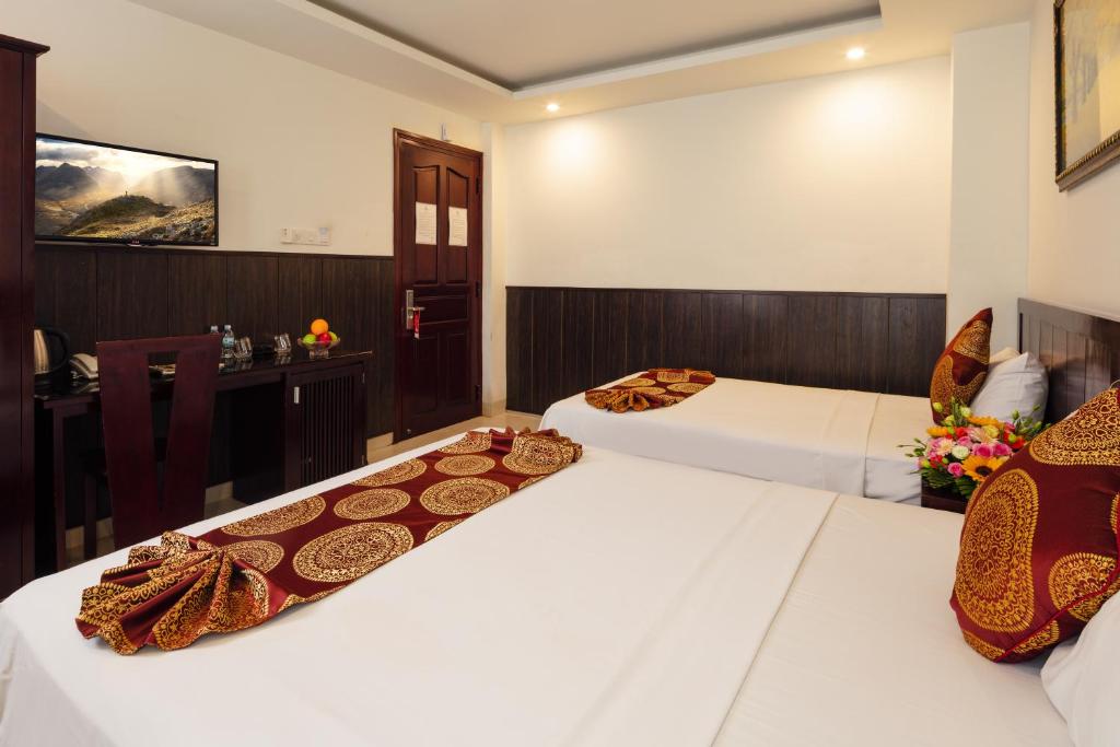 Postel nebo postele na pokoji v ubytování Azura Hotel