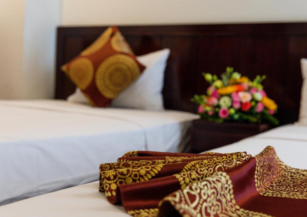 Postel nebo postele na pokoji v ubytování Azura Hotel