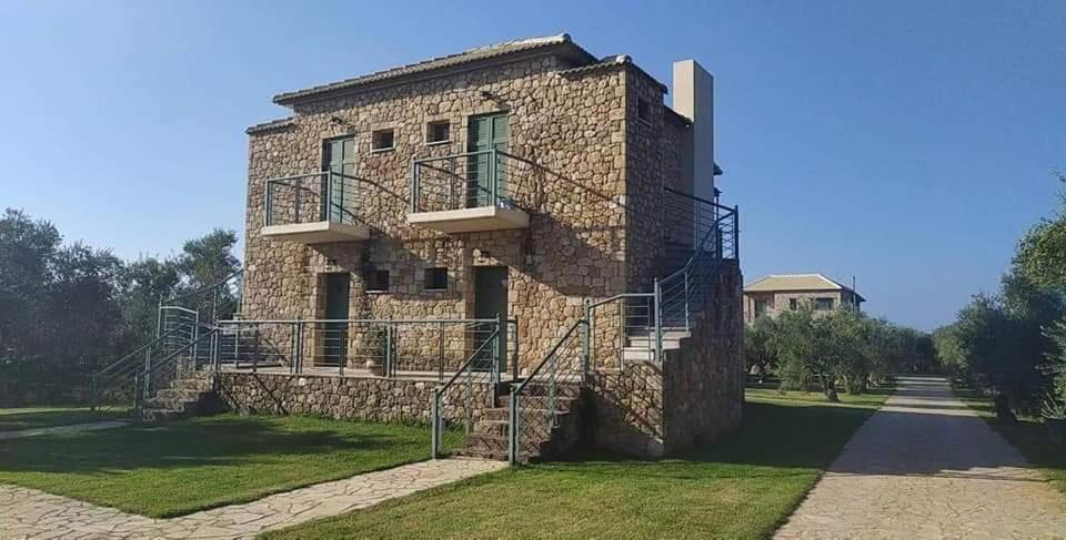 a stone building with a staircase in front of it at Megalos kampos in Marathopoli