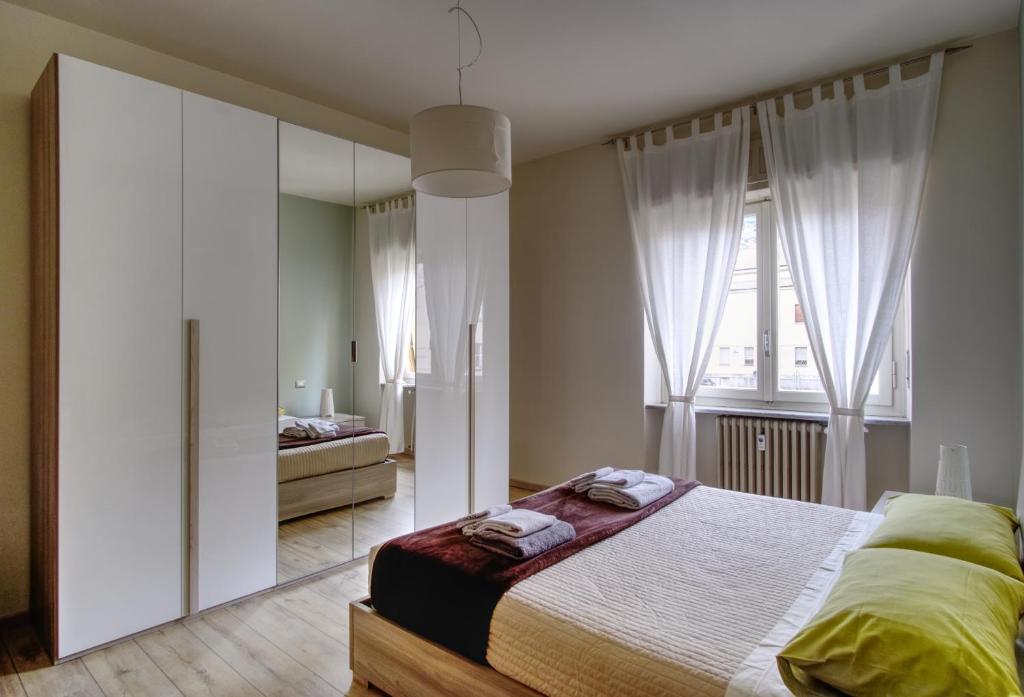 a bedroom with a bed and a large mirror at La maison du boulevard in Aosta