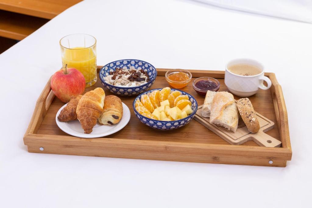 a tray of breakfast foods and a cup of coffee at Hotel Perrin - former Carlton in Luxembourg