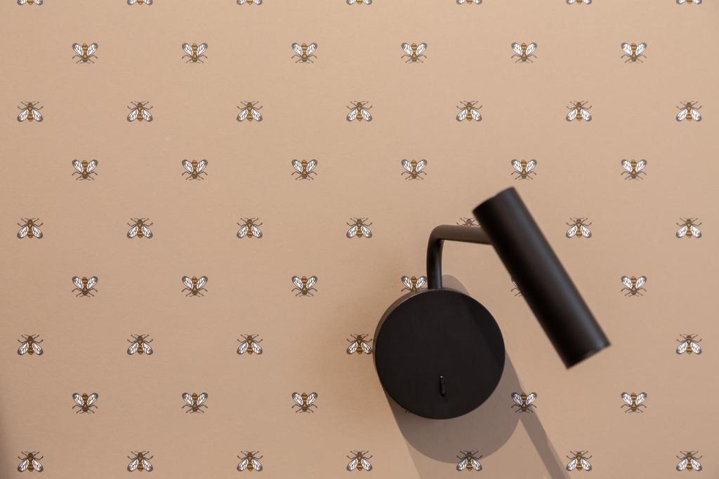 a close up of a black phone on a beige wall with skulls at Hotel Perrin - former Carlton in Luxembourg