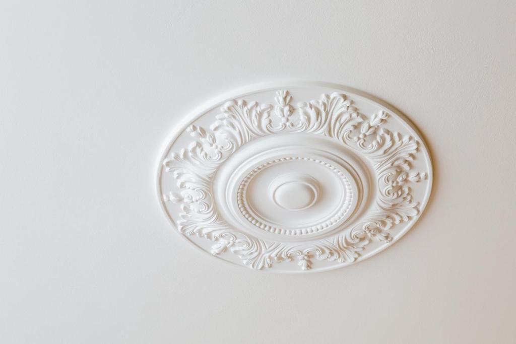 a white plate sitting on a white wall at Hotel Perrin - former Carlton in Luxembourg